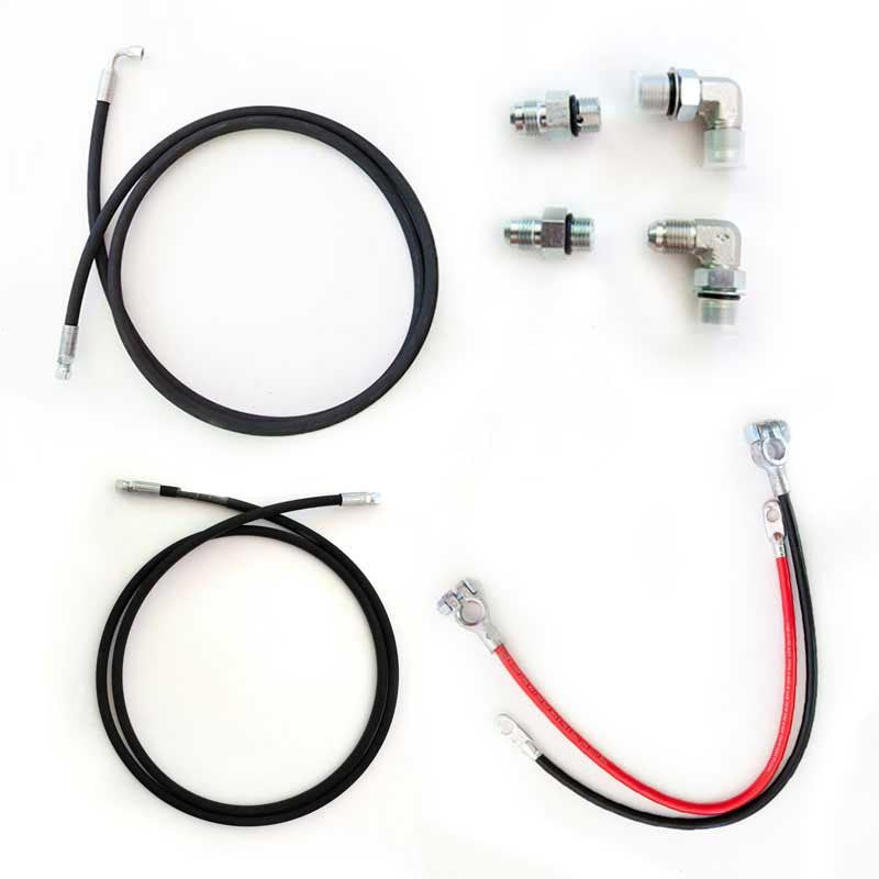 A close-up of black hydraulic pump hoses with metal ends and connectors, including replacement battery cables and hydraulic fittings.