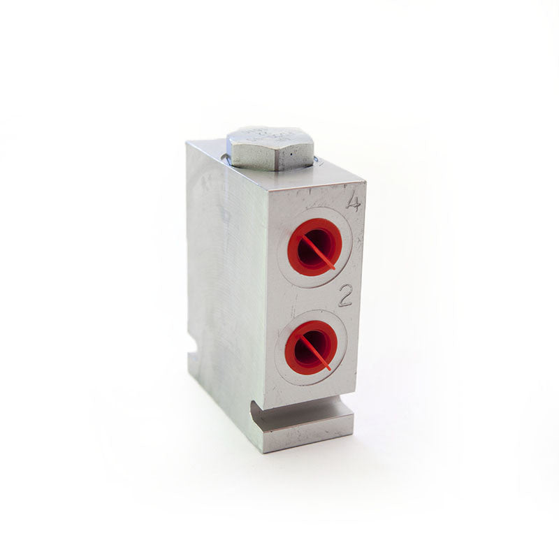 A silver cylinder with red holes, a white box, and a metal bar. High-performance hydraulic pump flow divider with synchronized flow in dividing and combining modes.