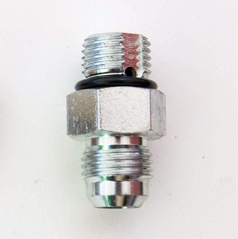 Close-up of a 3/8 Hydraulic Load Control Valve Fitting Steel, featuring a metal piece with a screw and a hole, designed for safety in hydraulic systems.